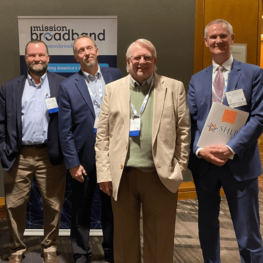 Matt Chandler, Trevor Gordon, and Brian Thibeau with the president of the Schools, Health & Libraries Broadband Coalition.