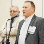 NETC representatives speaking at an industry event.